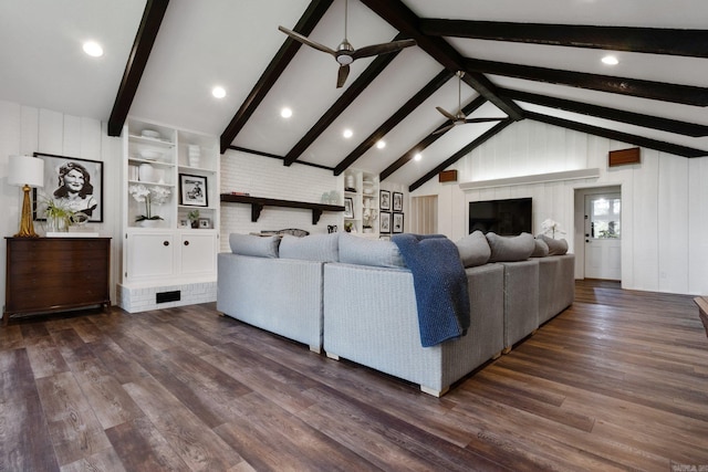 living room with built in shelves, ceiling fan, and dark hardwood / wood-style flooring