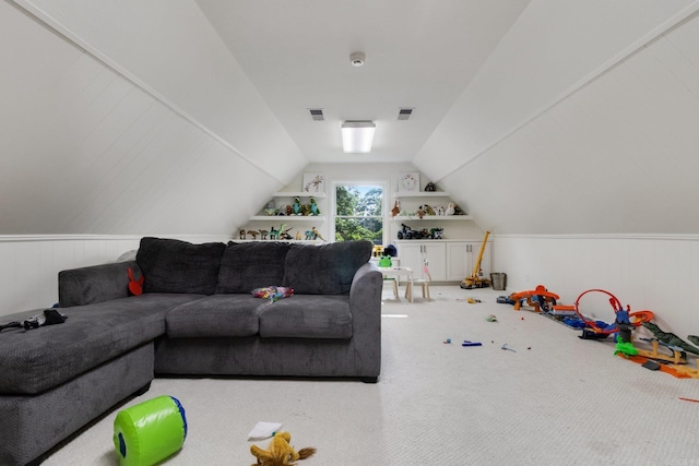 carpeted living room with vaulted ceiling