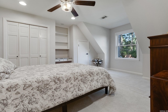 bedroom with a closet, light colored carpet, and ceiling fan