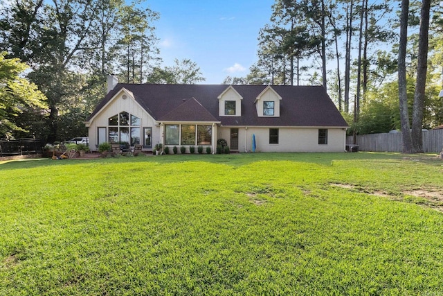 rear view of house with a yard