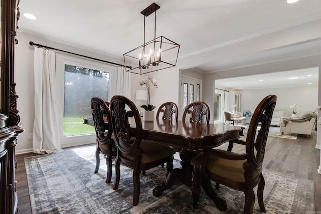 dining room featuring ornamental molding, dark wood-type flooring, and a notable chandelier