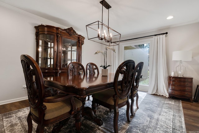 dining space with dark hardwood / wood-style flooring and ornamental molding