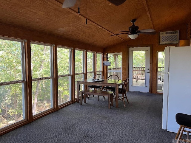 sunroom / solarium with ceiling fan, a healthy amount of sunlight, wooden ceiling, a wall mounted AC, and lofted ceiling