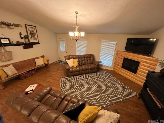 living room with vaulted ceiling, dark hardwood / wood-style floors, and a notable chandelier