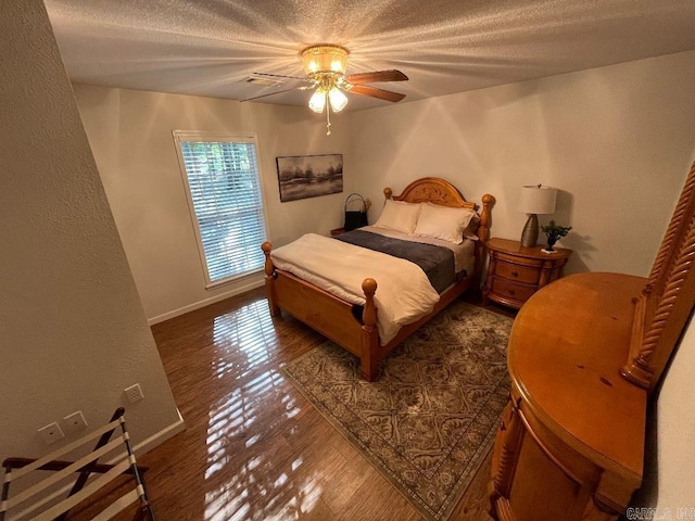 bedroom featuring ceiling fan and dark wood-type flooring