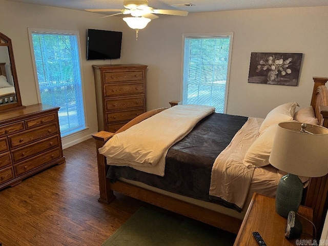 bedroom featuring ceiling fan and dark wood-type flooring