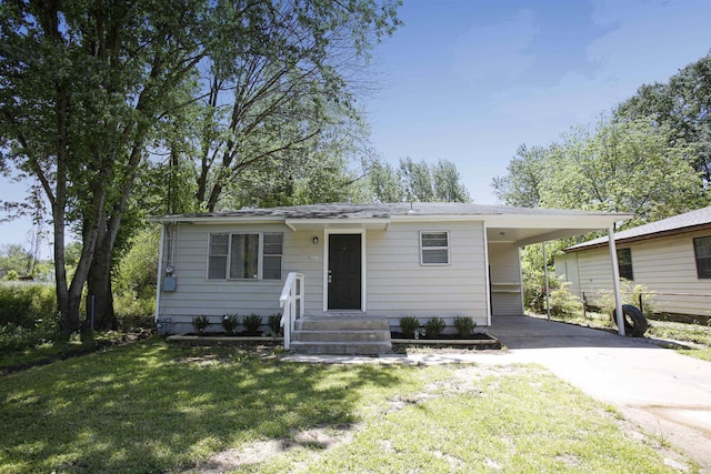 view of front facade with a carport and a front lawn