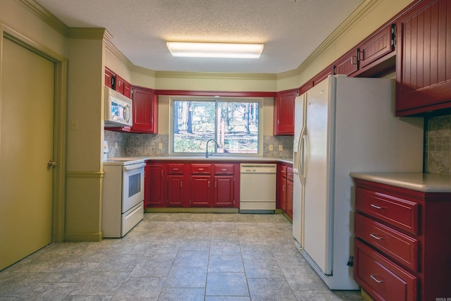 kitchen with a textured ceiling, white appliances, sink, and ornamental molding