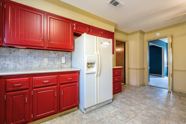 kitchen featuring decorative backsplash, white fridge with ice dispenser, and ornamental molding