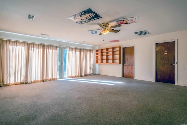 spare room featuring ceiling fan and carpet floors