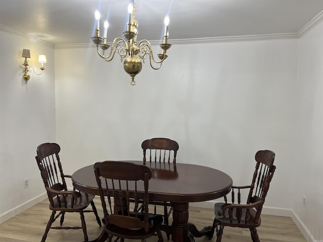 dining area featuring light hardwood / wood-style flooring, ornamental molding, and a chandelier