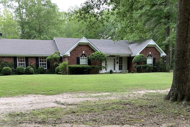 ranch-style home with a front lawn