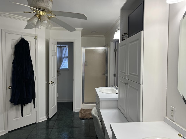 bathroom with a shower with door, crown molding, tile patterned floors, and vanity