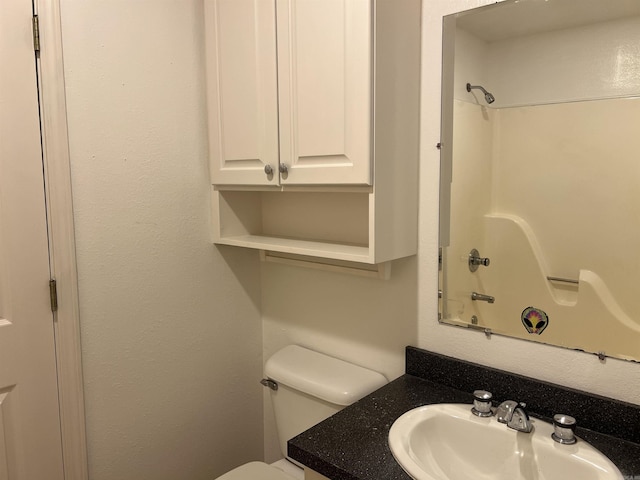 full bathroom featuring bathtub / shower combination, vanity, and toilet