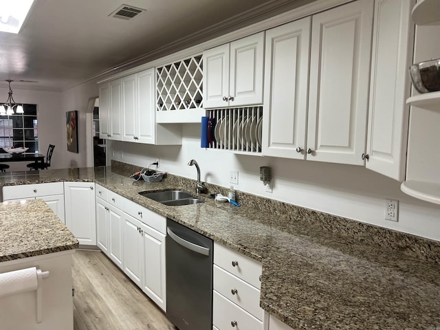 kitchen with dishwasher, sink, white cabinets, dark stone counters, and light wood-type flooring