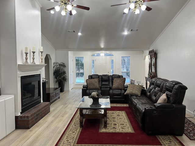 living room with ornamental molding, light wood-type flooring, and ceiling fan