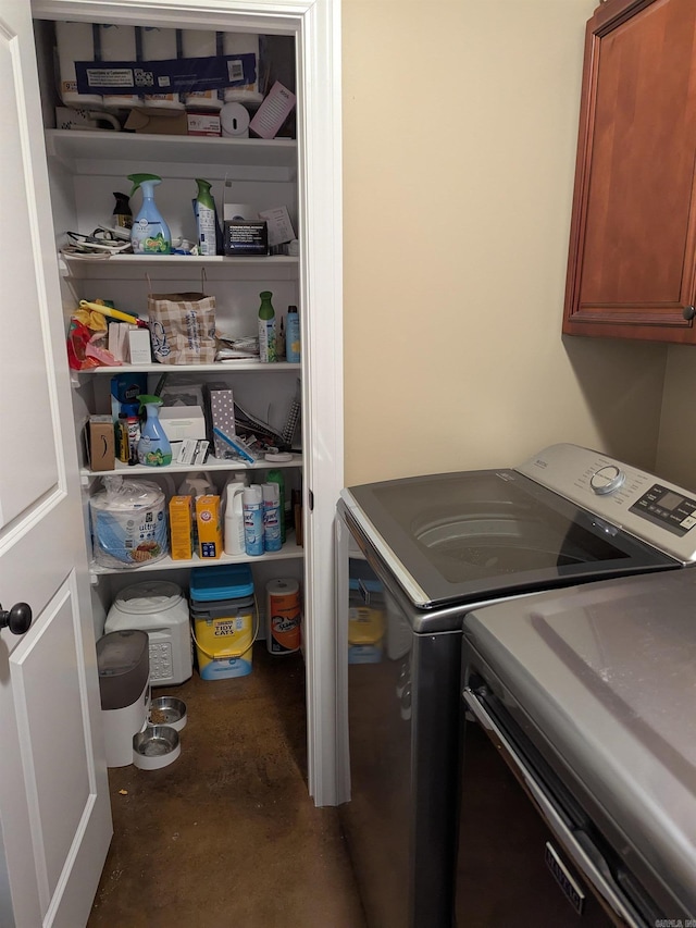 washroom featuring cabinets and separate washer and dryer