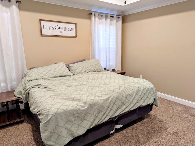 bedroom with carpet floors and crown molding