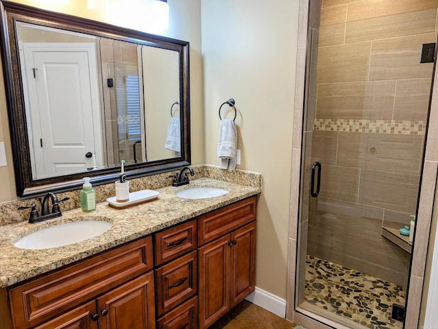 bathroom featuring a shower with door and vanity