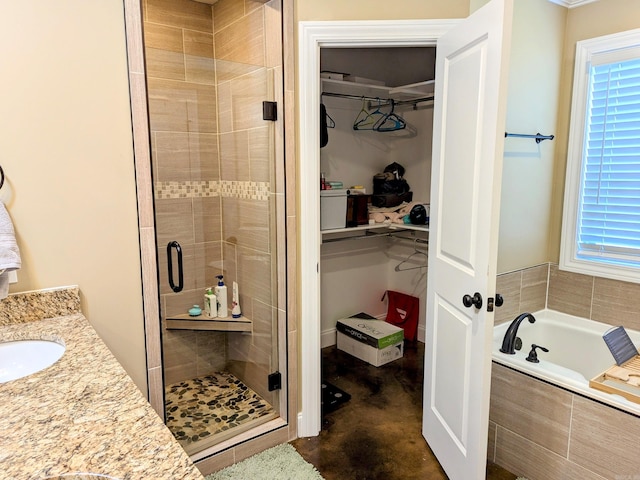 bathroom featuring plenty of natural light, vanity, and plus walk in shower