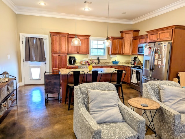 kitchen featuring a center island, sink, hanging light fixtures, a kitchen bar, and stainless steel appliances