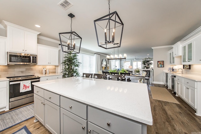 kitchen with white cabinets, a center island, and stainless steel appliances