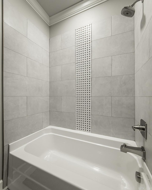 bathroom featuring tiled shower / bath combo and crown molding