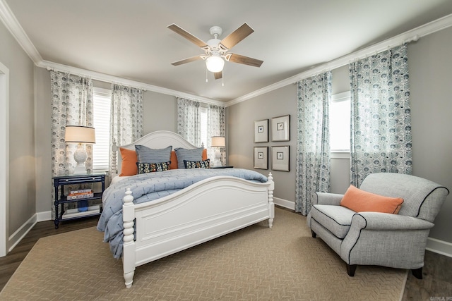 bedroom with hardwood / wood-style flooring, ceiling fan, crown molding, and multiple windows