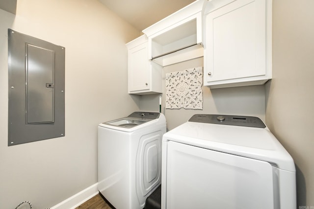 washroom with dark hardwood / wood-style flooring, cabinets, independent washer and dryer, and electric panel