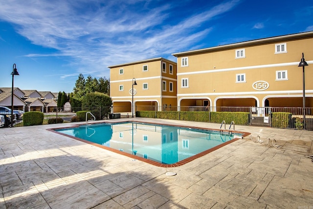 view of pool featuring a patio area and sink