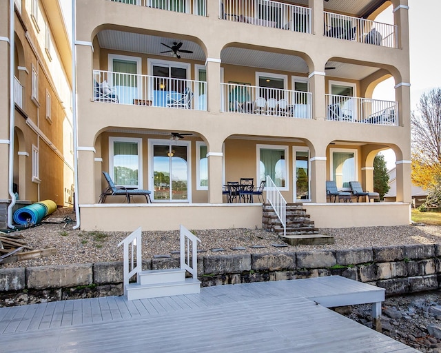 back of house with ceiling fan, a patio area, and a balcony