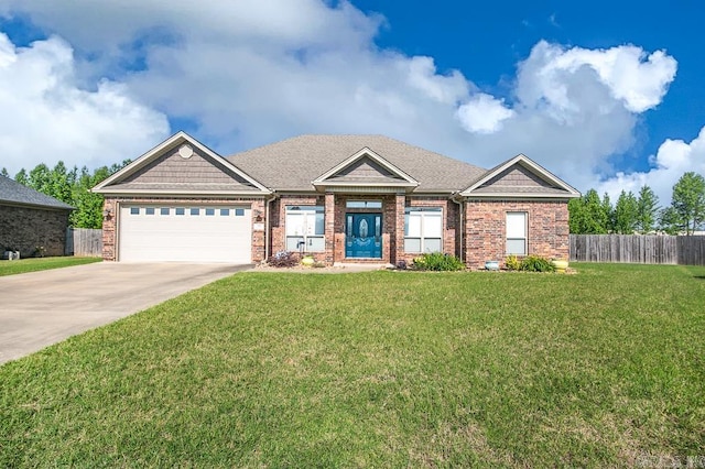 craftsman house with a garage and a front lawn