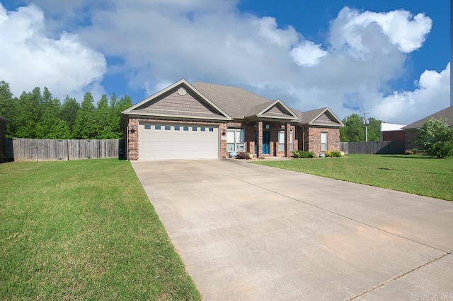 craftsman house with a front yard and a garage