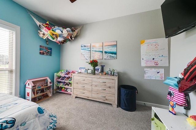 bedroom featuring light carpet and ceiling fan