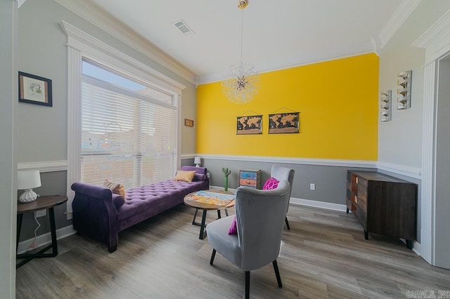 interior space featuring crown molding, hardwood / wood-style floors, and a chandelier