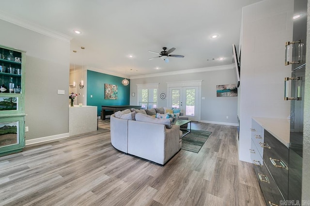 living room with hardwood / wood-style floors, french doors, crown molding, and ceiling fan