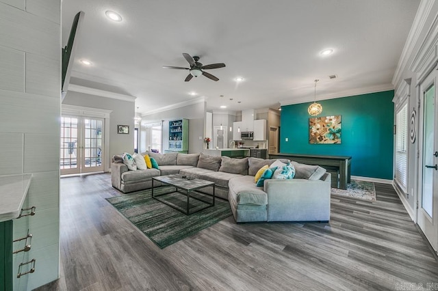 living room with ceiling fan, french doors, ornamental molding, and hardwood / wood-style flooring