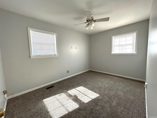 carpeted spare room featuring ceiling fan