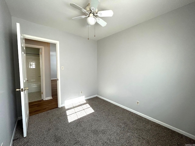 unfurnished bedroom featuring dark colored carpet and ceiling fan