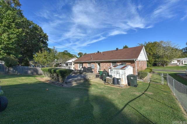 rear view of house featuring a yard