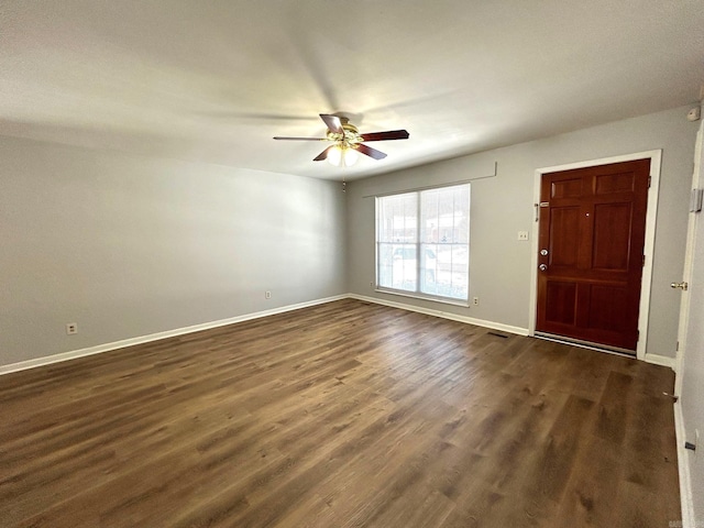 spare room with ceiling fan and dark wood-type flooring