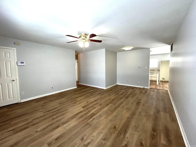 unfurnished living room with dark hardwood / wood-style floors and ceiling fan