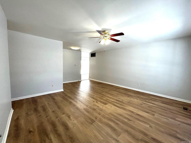 unfurnished room with ceiling fan and dark wood-type flooring