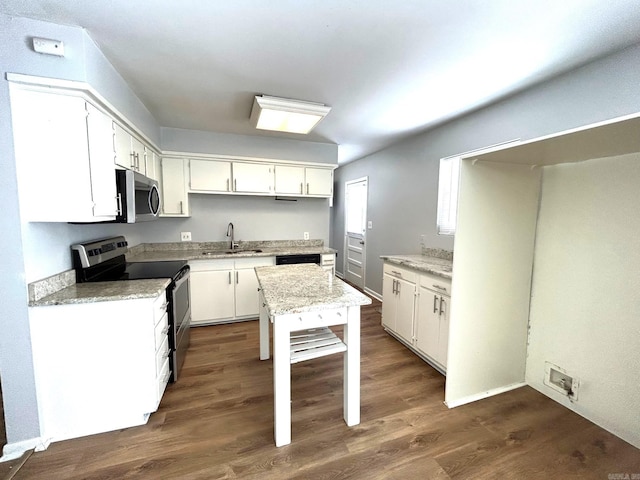 kitchen with dark hardwood / wood-style flooring, white cabinetry, sink, and stainless steel appliances