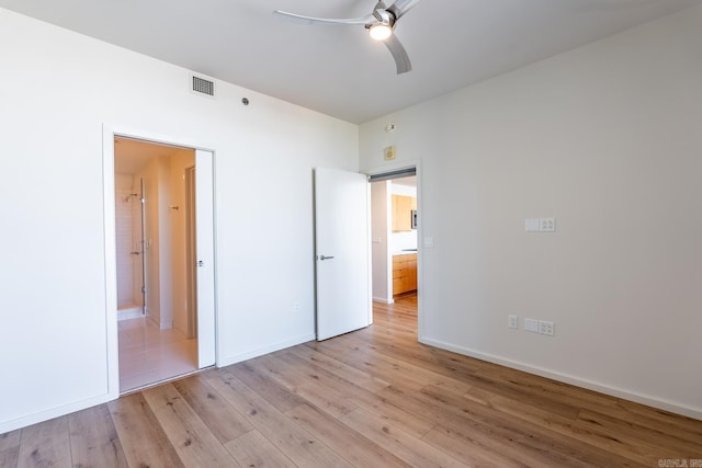 unfurnished bedroom with ceiling fan, light hardwood / wood-style floors, and ensuite bath