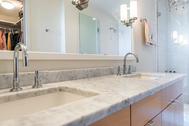 bathroom featuring vanity and tiled shower