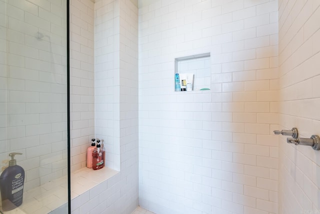 bathroom with a tile shower