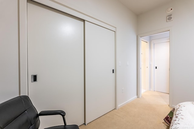 carpeted bedroom with a closet