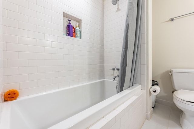 bathroom with tile patterned floors, shower / tub combo, and toilet