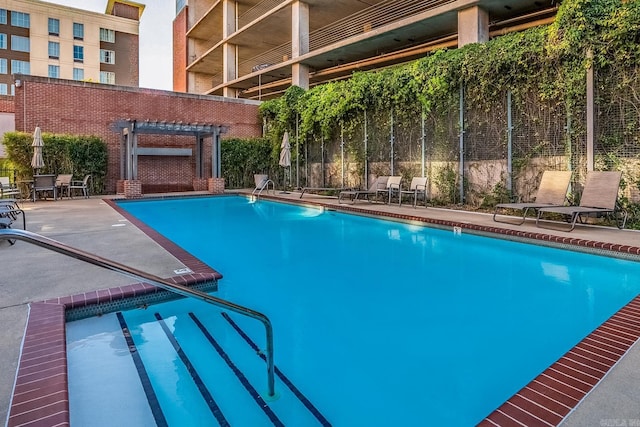 view of swimming pool with a pergola and a patio area